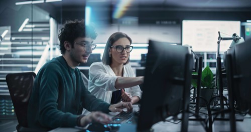 woman and men pointing on laptop screen 